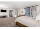 Bright and airy main bedroom with a sliding barn door leading to the bathroom at 30246 N 123Rd Ln, Peoria, AZ 85383