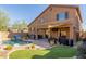 An expansive backyard features a pool, covered patio with TV, and manicured lawn perfect for outdoor living at 3206 W Sentinel Rock Rd, Phoenix, AZ 85086