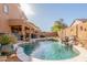 A private pool with rock features and a waterfall is surrounded by desert landscaping in the backyard at 3206 W Sentinel Rock Rd, Phoenix, AZ 85086