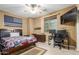 Comfortable bedroom featuring a ceiling fan, a large window and desk space at 3206 W Sentinel Rock Rd, Phoenix, AZ 85086