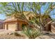 Inviting two-story home featuring a desert landscape and a three-car garage with stone accents at 3206 W Sentinel Rock Rd, Phoenix, AZ 85086