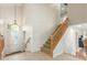 Elegant foyer with staircase and chandelier, offering a view of the front door at 3206 W Sentinel Rock Rd, Phoenix, AZ 85086