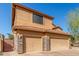 Three car garage with stone accents and tile roof against clear blue skies at 3206 W Sentinel Rock Rd, Phoenix, AZ 85086