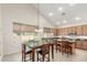 Eat-in kitchen features a vaulted ceiling, an island, and lots of natural light at 3206 W Sentinel Rock Rd, Phoenix, AZ 85086