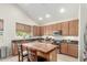 Eat-in kitchen offers an island with seating, stainless appliances, and ample cabinets at 3206 W Sentinel Rock Rd, Phoenix, AZ 85086