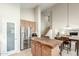 Bright kitchen includes an island with seating, pantry, and stainless appliances at 3206 W Sentinel Rock Rd, Phoenix, AZ 85086