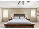 Close-up of the main bedroom showcasing a wooden bed frame with white and blue patterned bedding at 3206 W Sentinel Rock Rd, Phoenix, AZ 85086