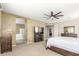Wide angle of the main bedroom, with a TV, ensuite bath, and neutral color palette at 3206 W Sentinel Rock Rd, Phoenix, AZ 85086