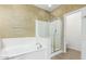 Neutral-colored bathroom featuring a soaking tub, glass enclosed shower, and tile floors at 3206 W Sentinel Rock Rd, Phoenix, AZ 85086