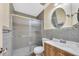 Bathroom featuring a glass shower and sink with wood cabinet at 3220 W Laurie Ln, Phoenix, AZ 85051