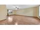 Spacious living room features wood flooring and a ceiling fan at 3220 W Laurie Ln, Phoenix, AZ 85051