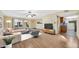 Bright living room featuring wood floors, neutral walls, and modern furnishings, seamlessly connecting to the kitchen at 3220 W Laurie Ln, Phoenix, AZ 85051