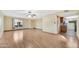 Open-concept living room with access to the kitchen and wood flooring at 3220 W Laurie Ln, Phoenix, AZ 85051