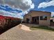 Backyard with artificial turf, stone patio and lush shrubbery; perfect for outdoor relaxation and entertainment at 3310 E Fremont Rd, Phoenix, AZ 85042