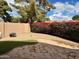 Landscaped backyard with decorative rock, putting green, green bushes, and flowers at 3310 E Fremont Rd, Phoenix, AZ 85042
