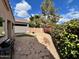 Landscaped backyard with decorative rock, green bushes, red flowers, and a putting green at 3310 E Fremont Rd, Phoenix, AZ 85042