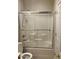Bathroom featuring shower and tub combo with sliding glass doors and white subway tile at 3310 E Fremont Rd, Phoenix, AZ 85042