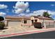 Charming single-story home featuring a two-car garage, desert landscaping, and a red tiled roof at 3310 E Fremont Rd, Phoenix, AZ 85042