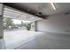 Open garage with speckled floor and view of the neighborhood showcasing the home's entrance at 3310 E Fremont Rd, Phoenix, AZ 85042