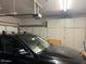 Well-organized garage featuring ample storage cabinets, car, and garage door system at 3310 E Fremont Rd, Phoenix, AZ 85042