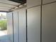 Garage interior with white built in cabinets and open garage door at 3310 E Fremont Rd, Phoenix, AZ 85042
