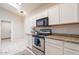 Well-lit kitchen featuring white cabinets, granite countertops, and stainless steel appliances at 3310 E Fremont Rd, Phoenix, AZ 85042