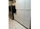 Kitchen pantry with white cabinets, granite countertops, and stainless steel refrigerator at 3310 E Fremont Rd, Phoenix, AZ 85042