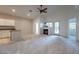 Spacious living room featuring neutral carpet, a fireplace, and a ceiling fan at 3310 E Fremont Rd, Phoenix, AZ 85042