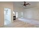 Spacious living room with a cozy fireplace, ceiling fan, and ample natural light at 3310 E Fremont Rd, Phoenix, AZ 85042