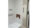 Shower with white tile, handrails, and a wood shower seat at 3310 E Fremont Rd, Phoenix, AZ 85042
