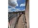 Desert landscaped side yard with rocks, a black metal fence, and blue skies at 3310 E Fremont Rd, Phoenix, AZ 85042