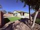 A well-manicured backyard with artificial turf, a pool, and neutral toned exterior of the home at 3717 E Lodgepole Dr, Gilbert, AZ 85298