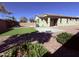 A nicely landscaped backyard includes artificial turf, decorative rock, neutral toned exterior of the home, and pool at 3717 E Lodgepole Dr, Gilbert, AZ 85298