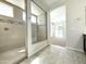 Bright bathroom boasting tiled shower with glass door and views of the carpeted bedroom at 3717 E Lodgepole Dr, Gilbert, AZ 85298
