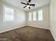 Cozy bedroom with carpet flooring, three windows with shutters, and a modern ceiling fan at 3717 E Lodgepole Dr, Gilbert, AZ 85298