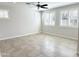 Light and airy bedroom featuring tile floors, neutral paint, a ceiling fan, and abundant natural light from shuttered windows at 3717 E Lodgepole Dr, Gilbert, AZ 85298