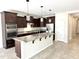 Well-lit kitchen showcases granite counters, stainless steel appliances, pendant lighting and a large island with seating at 3717 E Lodgepole Dr, Gilbert, AZ 85298