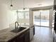 Open kitchen with island, granite counters, stainless appliances, and seamless access to a backyard pool and patio at 3717 E Lodgepole Dr, Gilbert, AZ 85298