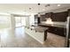 Bright, open-concept kitchen with granite counters, stainless appliances, island seating, and backyard access at 3717 E Lodgepole Dr, Gilbert, AZ 85298