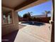 An inviting backyard pool features a waterfall surrounded by decorative rock and lush palm trees at 3717 E Lodgepole Dr, Gilbert, AZ 85298