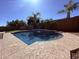A sparkling backyard pool features a waterfall and ample deck space for entertaining guests at 3717 E Lodgepole Dr, Gilbert, AZ 85298