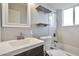 Updated bathroom featuring a shower-tub, a modern sink, and sleek shelving at 3718 W Columbine Dr, Phoenix, AZ 85029