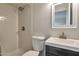 A bathroom featuring tiled walls, a modern sink, and a stylishly framed mirror at 3718 W Columbine Dr, Phoenix, AZ 85029