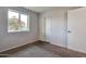 Cozy bedroom features a window with a view, closet with sliding doors, and carpet flooring at 3718 W Columbine Dr, Phoenix, AZ 85029