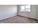 Empty bedroom with window and carpet flooring, ready for personalization at 3718 W Columbine Dr, Phoenix, AZ 85029