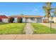 Inviting single-story home features a lush green lawn with a sidewalk, providing a welcoming entrance at 3718 W Columbine Dr, Phoenix, AZ 85029