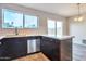 Well-appointed kitchen featuring dark cabinets, stainless steel appliances, and a bright window at 3718 W Columbine Dr, Phoenix, AZ 85029
