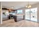 Open kitchen with stainless appliances, center island, tile floors, and sliding door access to backyard at 3718 W Columbine Dr, Phoenix, AZ 85029
