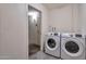 Laundry room featuring a modern washer and dryer set and grey tile flooring at 3718 W Columbine Dr, Phoenix, AZ 85029