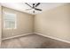 Bright bedroom with neutral walls, carpet, and a ceiling fan for added comfort at 41290 W Ganley Way, Maricopa, AZ 85138